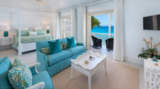 Master suite with a four-poster bed and sea-view balcony at Mahogany Bay – Chanel No.5, luxury villa, Barbados