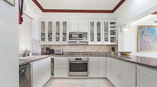 Fully equipped kitchen with granite worktops and glass-front cabinets at Fathom's End, Barbados