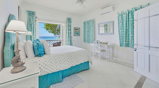 Sea-view bedroom decorated in soft turquoise at Fathom's End, a private villa in Barbados