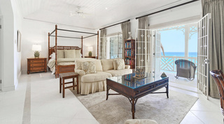 Master suite with a four-poster bed and sea-view balcony at Fathom's End, a luxury villa in Barbados