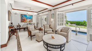 Open-plan living room opening to the pool terrace and sea at Fathom's End, a luxury villa in Barbados