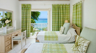 Twin bedroom dressed in green checks with limed wood furniture and sea views, Mahogany Pod, Barbados