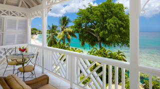 Glass-topped bistro table on the covered terrace at Mahogany Pod, beachfront villa in Barbados