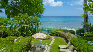 Lawn and stepping stone path down to the beach gate at Mahogany Pod, beachfront villa, Barbados
