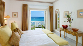 Bedroom with a king bed and doors opening to a sea-facing terrace, Mahogany Pod villa rental, Barbados