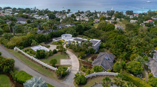 Aerial over the gated drive to Monkey Hill in Sugar Hill, with the Barbados west coast and sailing boats beyond