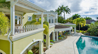 Curved colonnade and loungers lining the pool deck, seen from above at Monkey Hill in Barbados