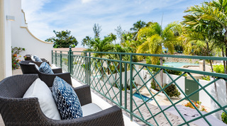 First floor terrace seating behind a green railing with garden views at Mullins Bay 10 Pandora, Barbados