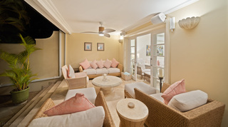 Evening on the terrace lounge with wicker seating and a stone pedestal table, Mullins Bay 13 Coco villa, Barbados