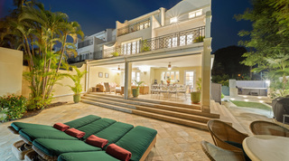 Two storeys of balconies above the lit terrace lounge and dining area, Mullins Bay 13 Coco villa, Barbados