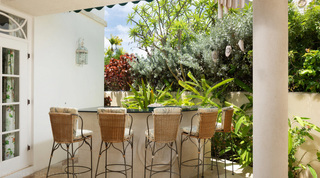 Wicker stools at the covered terrace bar of Mullins Bay Villa – Twin Palms, a holiday villa in Barbados