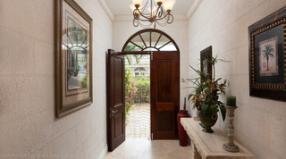 Front door beneath a radiating fanlight in the entrance hall of Mullins Bay Villa – Twin Palms, west coast Barbados