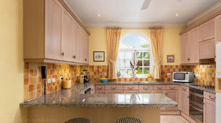 Orange and ochre splashback tiles under an arched kitchen window at Mullins Bay Villa – Twin Palms, Barbados villa rental