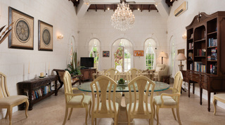 Glass dining table on a carved coral stone pedestal at Mullins Bay Villa – Twin Palms, private villa in Barbados
