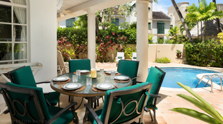 Glass-topped table set for six beside the pool at Mullins Bay Villa – Twin Palms, Barbados villa rental