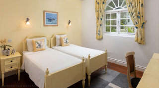 Yellow twin room with monkey cushions and a racehorse print at Mullins Bay Villa – Twin Palms, Barbados
