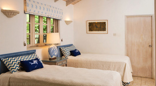 Twin bedroom with blue chevron cushions and a garden window at Mullins Mill, Barbados