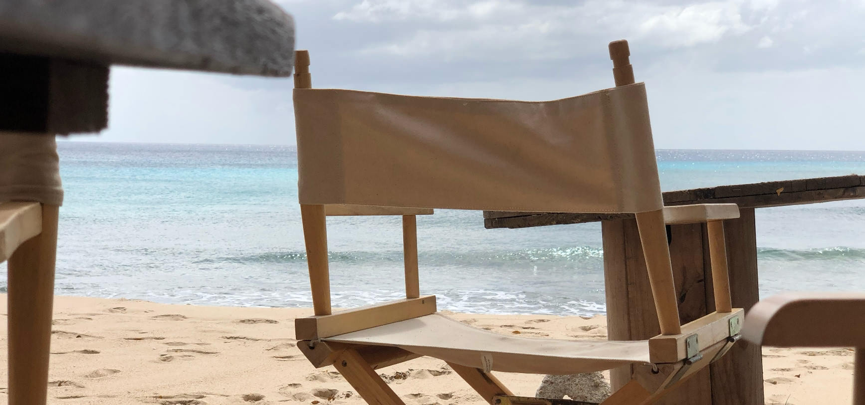 Canvas chair on the beach looking out to sea
