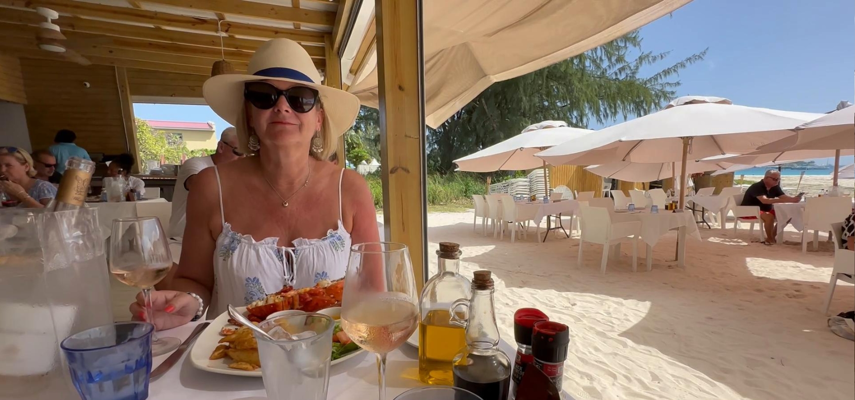 Lisa sat at a table by the beach enjoying her lunch at Lobster Alive