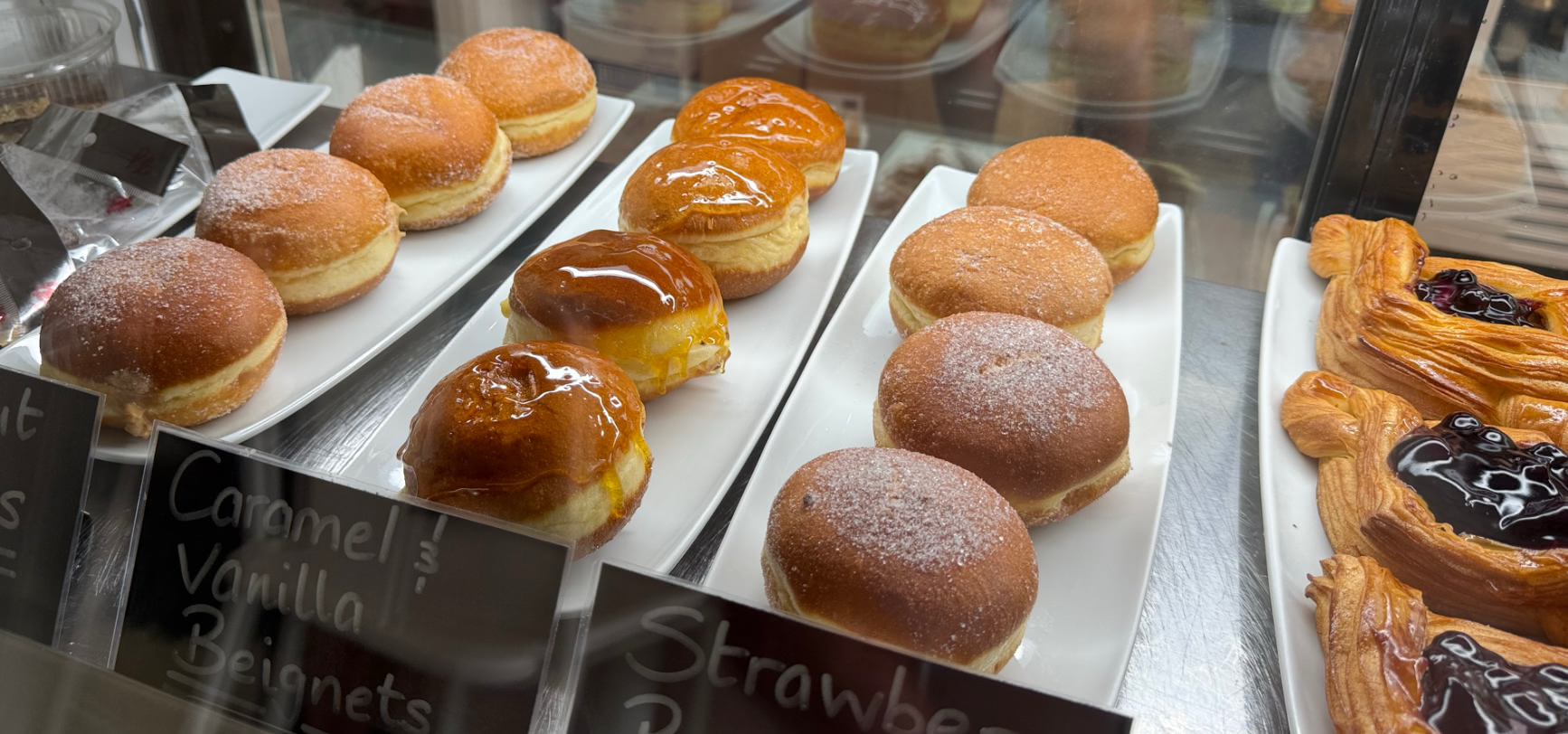 A Caramel and Vanilla Beignet from The Cliff Bakery in the display case