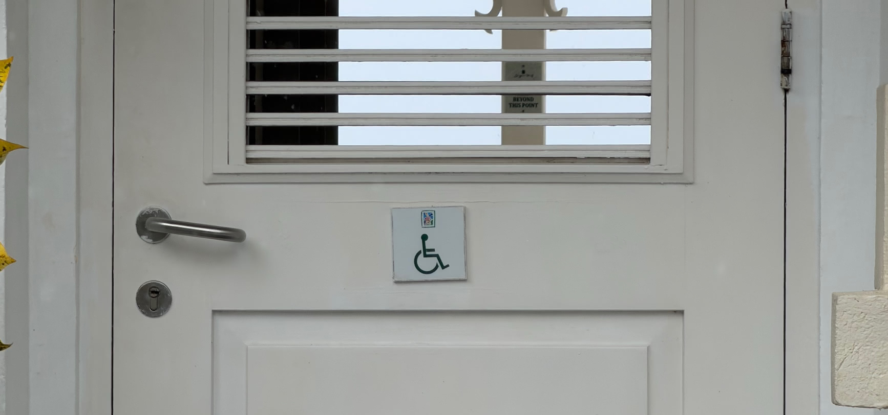 Wheelchair-accessible entrance at the Sugar Hill clubhouse, marked with an accessibility sign, Barbados