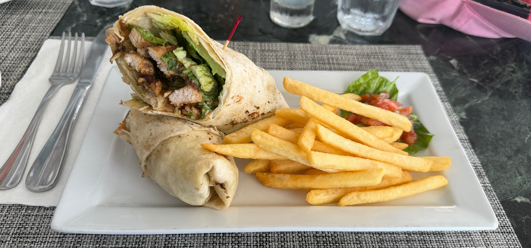 Jerk chicken wrap with hand-cut fries and a side salad at The Deck, Sugar Hill clubhouse, Barbados