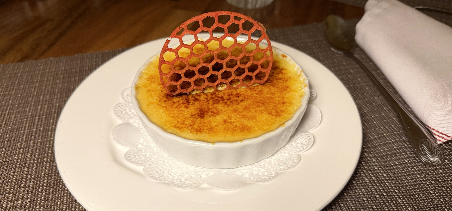 A crème brûlée under a honeycomb tuile at Derrière, Limegrove