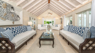 Whitewashed vaulted living room with facing cream sofas and a fish painting, Queens Fort Pavilion holiday villa in Barbados