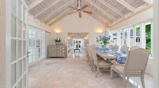 Dining room set with blue cornflowers and a palm-print runner at Queens Fort Pavilion, a luxury villa in Barbados