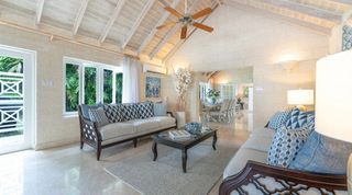 Living room sofa and ceiling fan with the dining room beyond, Queens Fort Pavilion villa in St. James, Barbados
