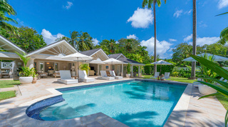 Private pool with a curved tiled step and white sun loungers at Queens Fort Pavilion, a luxury villa in St. James, Barbados