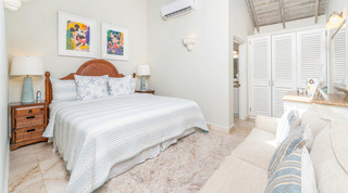 Bedroom with Mickey Mouse pop-art prints and a cream sofa at Queens Fort Pavilion, a family-friendly villa in Barbados