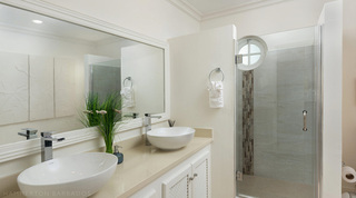 En-suite bathroom at Royal Villa 17, Barbados, with twin vessel basins and a walk-in shower