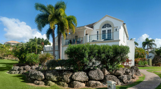 Royal Villa 17, a refurbished holiday villa rental in Royal Westmoreland, Barbados, behind a coral-stone rockery