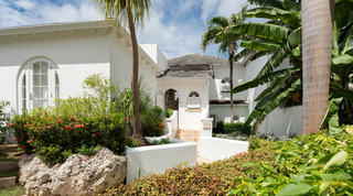 Arched entrance porch framed by tropical planting at Royal Villa 17 in St. James, Barbados