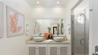 En-suite bathroom at Royal Villa 17 in Barbados, with lattice-front cabinets and twin basins