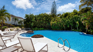 Sun loungers beside the communal infinity-edged pool at Royal Villa 17, luxury villa in Barbados