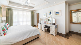 Smugglers Cove 3 bedroom with flamingo cushions, a triple-mirror dressing table and beach watercolours, Barbados
