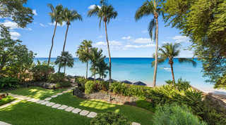 Tall coconut palms over lawns and the turquoise sea of Paynes Bay, Smugglers Cove 3 beachfront apartment, Barbados