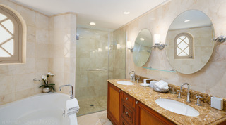 Double vanity with tilting mirrors beside the walk-in shower, St. Peter's Bay 104 apartment rental in Barbados