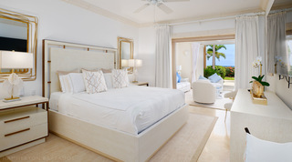 St. Peter's Bay 104 main bedroom with layered wire-framed mirrors and doors open to the terrace and sea, Barbados