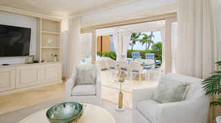 Sliding doors pulled back from the living room to the terrace and sea at St. Peter's Bay 104, luxury apartment in Barbados