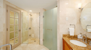 Glass walk-in shower, frosted glass partition and glazed door in a bathroom at St. Peter's Bay 104, Barbados