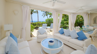 Columned terrace lounge opening to sun loungers and the Caribbean Sea at St. Peter's Bay 104, beach apartment in Barbados