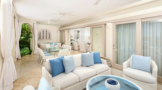 Covered terrace with a hot tub, dining table and sliding doors to the living room at St. Peter's Bay 104 in Barbados