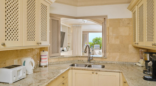 Serving hatch with lattice shutters above the kitchen sink, looking through to the sea from St. Peter's Bay 104, Barbados