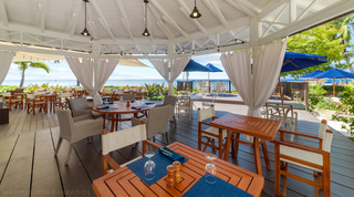 Curtained dining pavilion with sea views at the resort restaurant of St. Peter's Bay 106 near Speightstown, Barbados