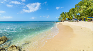 Gentle surf on golden sand by St. Peter's Bay 106, beach apartment on the west coast of Barbados