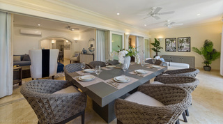 Terrace dining table at St. Peter's Bay 106 with woven rope chairs and white china, open to the living room, Barbados