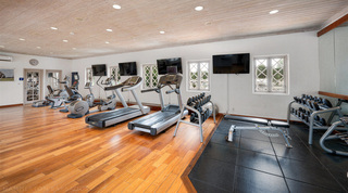 Dumbbell racks and a weight bench in the resort gym at St. Peter's Bay 204, west coast Barbados